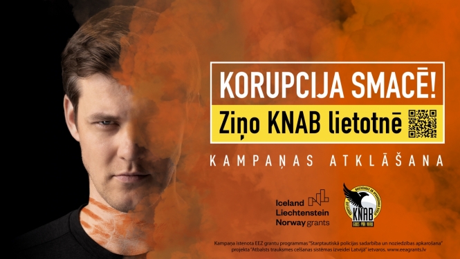 Attēlā redzams Magnuss Eriņš un informācija, ka "Korupcija SMACĒ! Ziņo KNAB lietotnē".