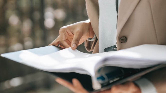 Woman holding a folder with documents