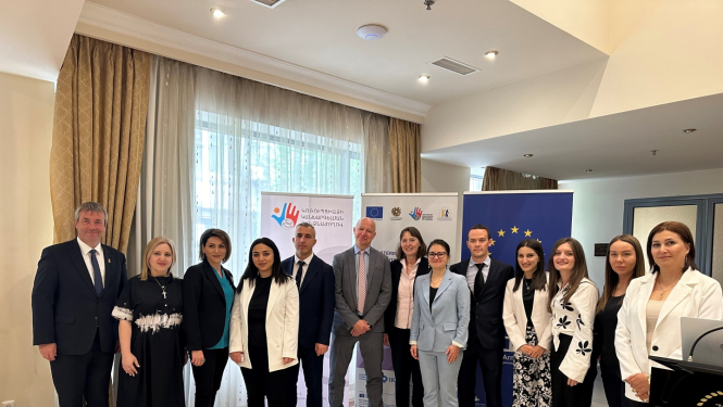 13 Twinning projektā iesaistīte pārstāvji kopīgā fotogrāfijā iekštelpās