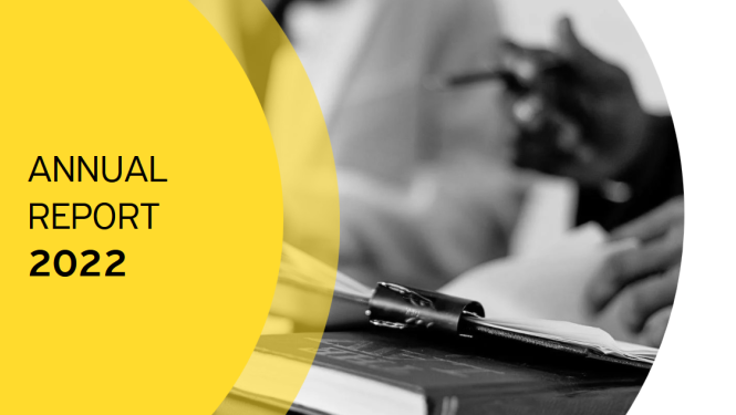 Black and white picture with notebook and hands, as well as a shape filled with yellow colour and black tekst "Annual Report 2022"