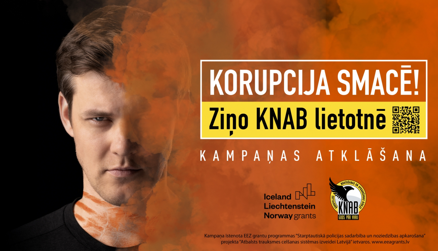 Attēlā redzams Magnuss Eriņš un informācija, ka "Korupcija SMACĒ! Ziņo KNAB lietotnē".